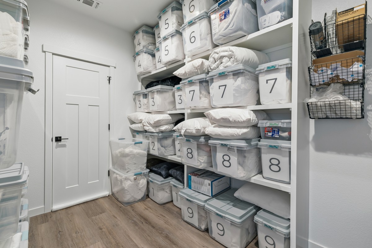 Linen storage room with numbered bins of bedding and pillows