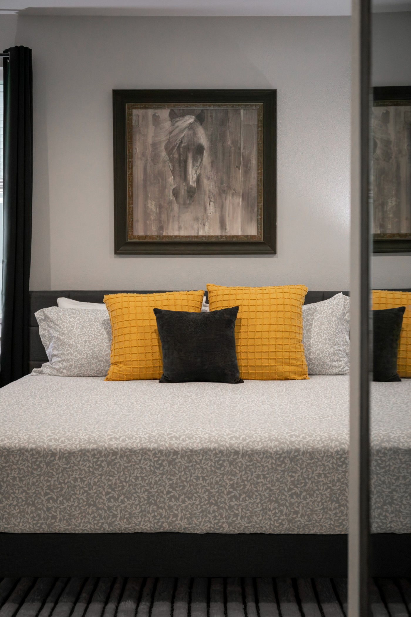 Main barndominium bedroom — king bed, equestrian art, mirrored closet