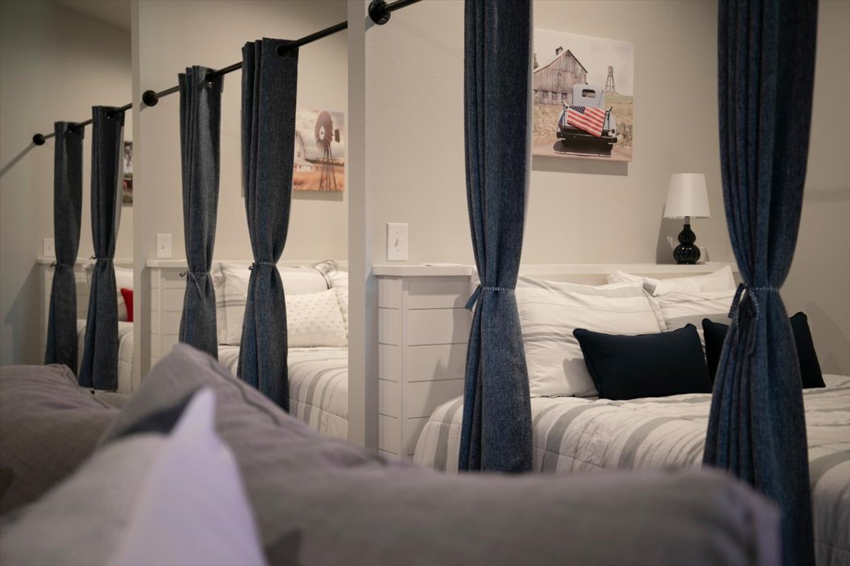 Bunk room with full-size beds and privacy curtains